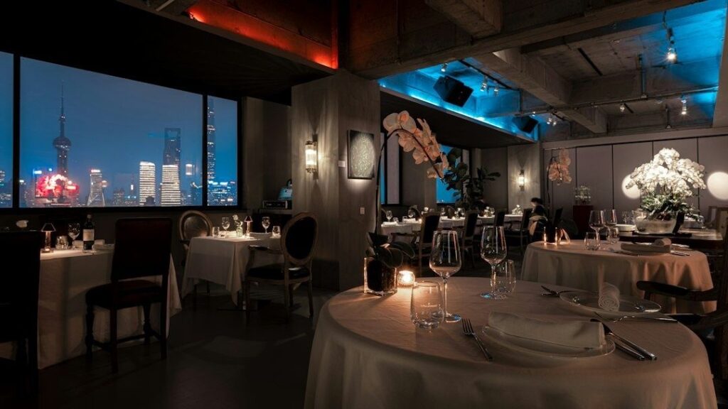 Elegant restaurant dining room with city views and candlelit tables